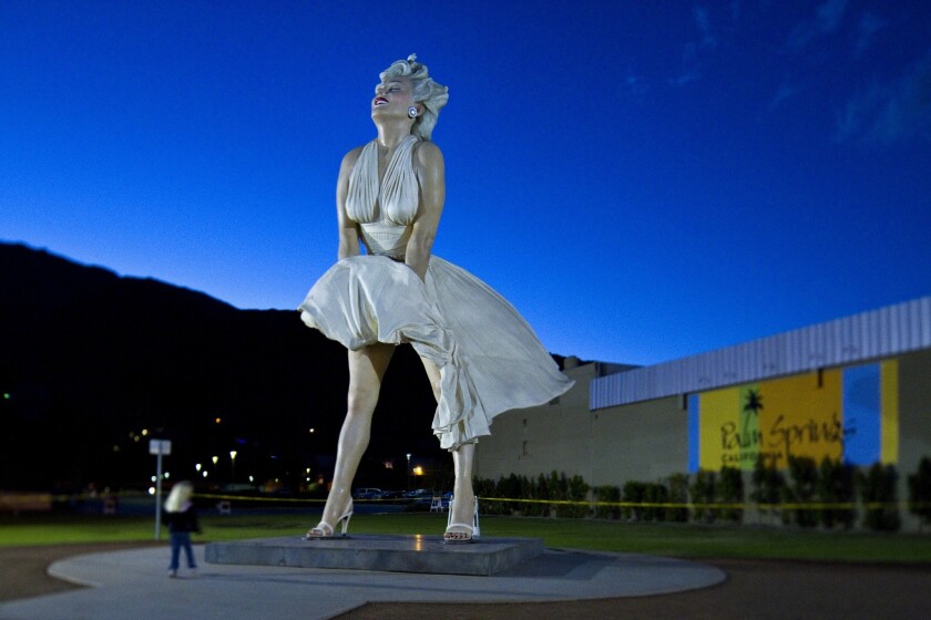 A person is dwarfed by the Forever Marilyn statue in Palm Springs