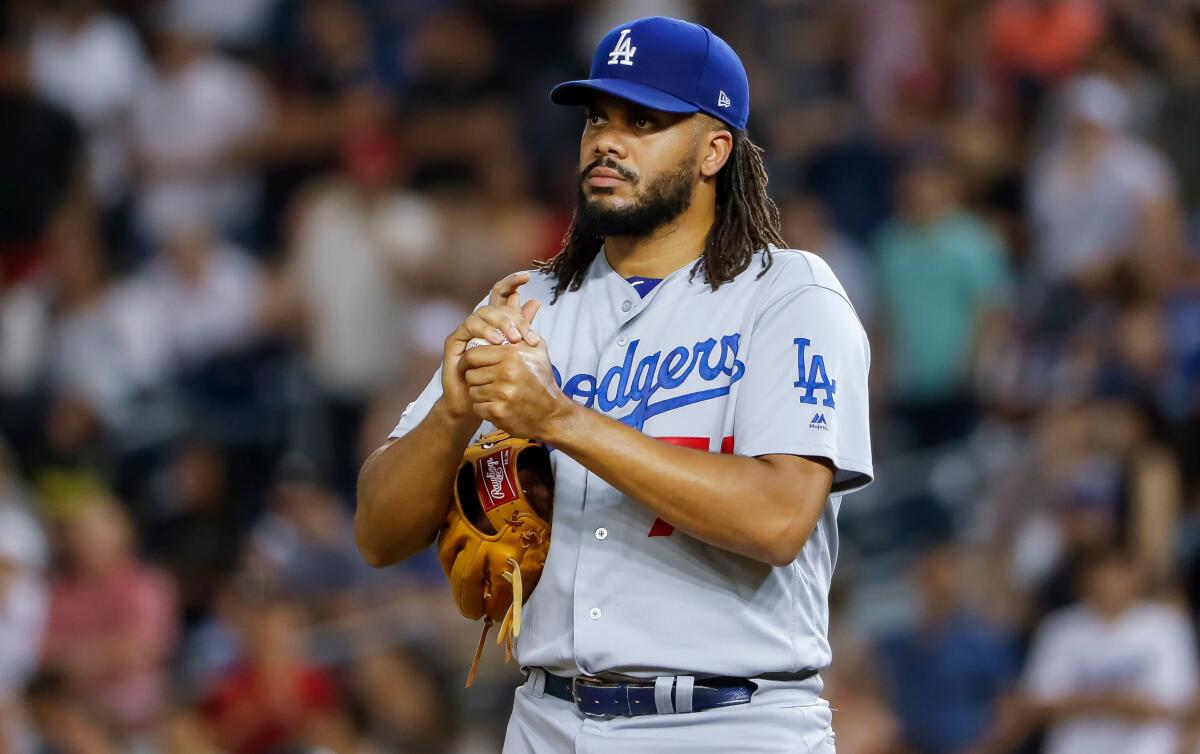 Dodgers closer Kenley Jansen rubs up a new baseball in the ninth inning against the Washington Nationals in Washington, D.C. on Friday.