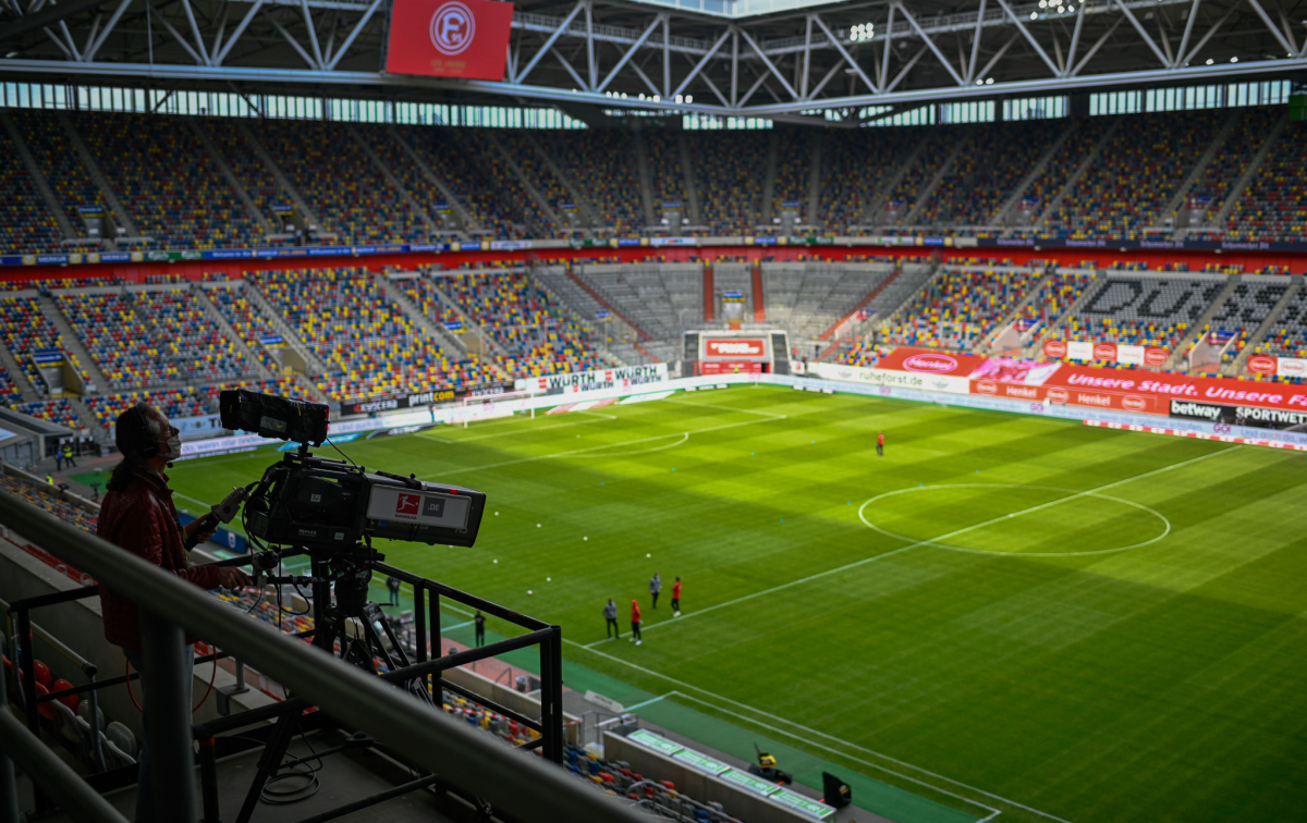 A TV camera operator works before a German first division Bundesliga football match in May in Duesseldorf.