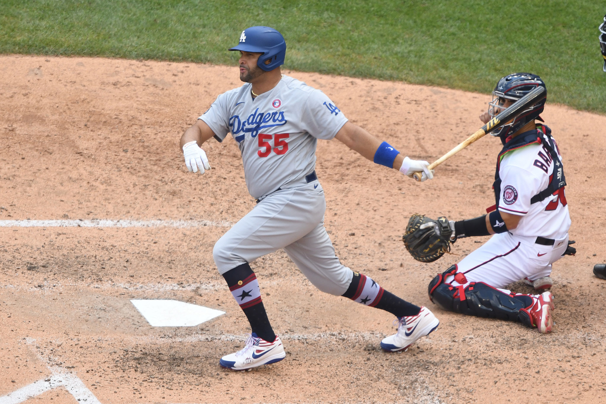 Albert Pujols hits a run-scoring single in the seventh inning during the Dodgers' 5-1 win.