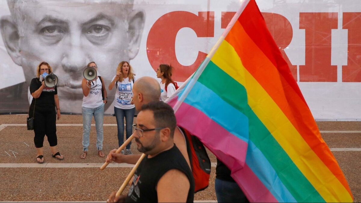 Participants attend a demonstration in Tel Aviv on July 22 to protest a new surrogacy law that does not include gay couples.