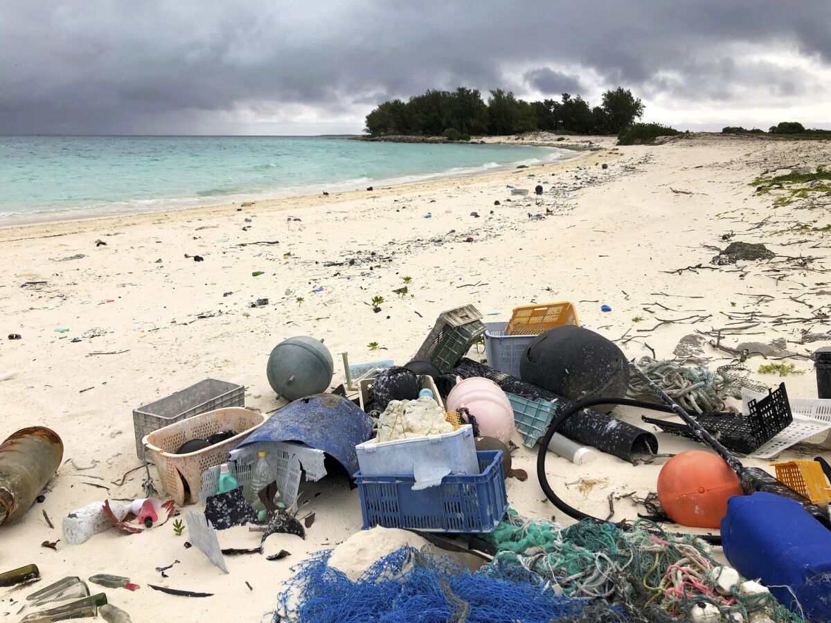 Trash carried by ocean currents is piled on a beach on Midway Atoll in the northwestern Hawaiian Islands in 2019. 