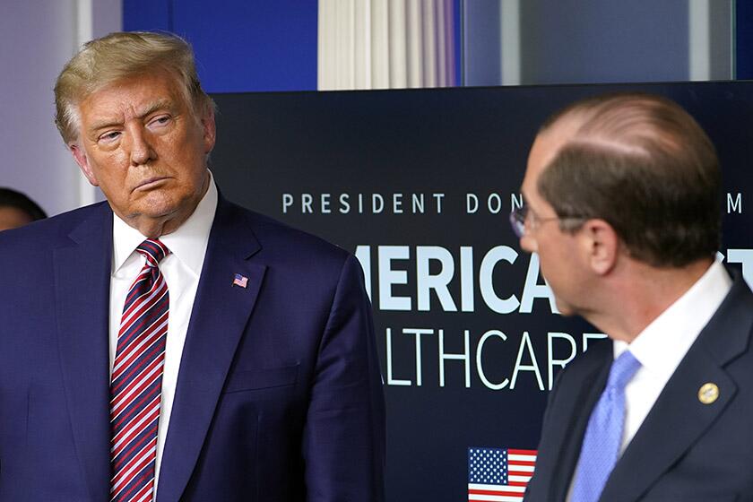 President Trump and Health and Human Services Secretary Alex Azar during a news conference in Washington on Friday.