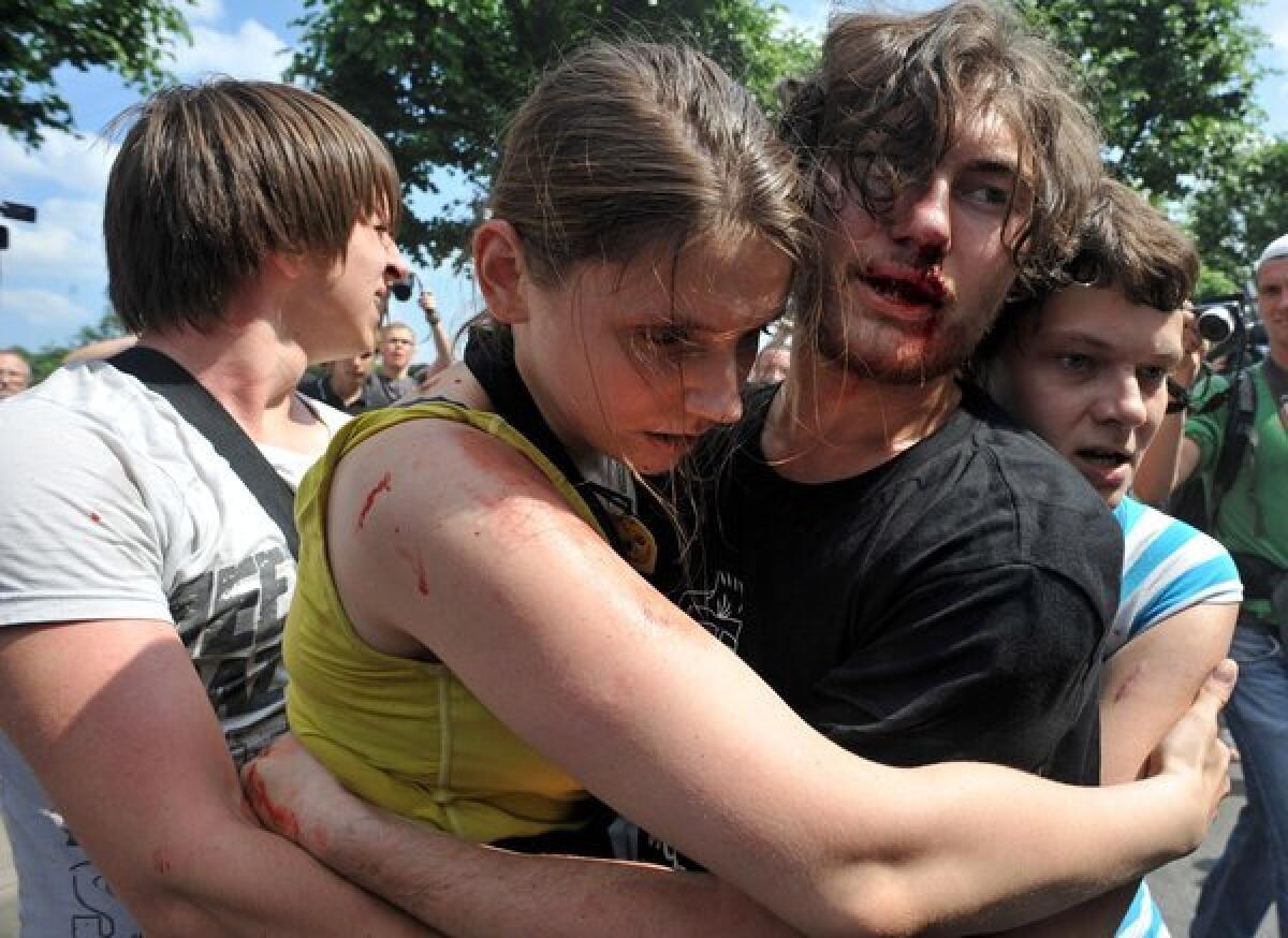 Gay rights activists embrace after clashes with anti-gay demonstrators during a gay pride event in St. Petersburg in June. Russian police arrested dozens of people.