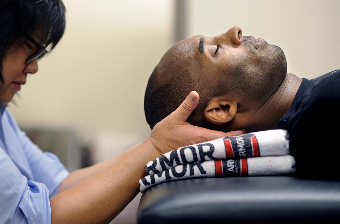 Kobe Bryant gets a massage from physical therapist Judy Seto before a game agiainst the Rockets in Houston.