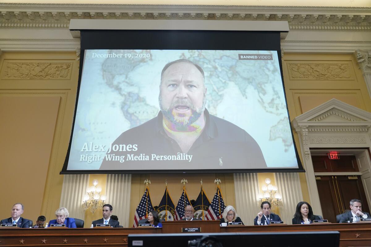 FILE - In this July 12, 2022 file photo, a video showing Alex Jones is shown as the House select committee investigating the Jan. 6 attack on the U.S. Capitol holds a hearing at the Capitol in Washington. An attorney representing two parents who sued Jones over his false claims about the Sandy Hook massacre says the U.S. House Jan. 6 committee has requested two years’ worth of records from Jones’ phone. Attorney Mark Bankston said in court Thursday, Aug. 4, 2022 that the committee investigating the attack on the U.S. Capitol has requested the digital records. (AP Photo/Jacquelyn Martin, File)