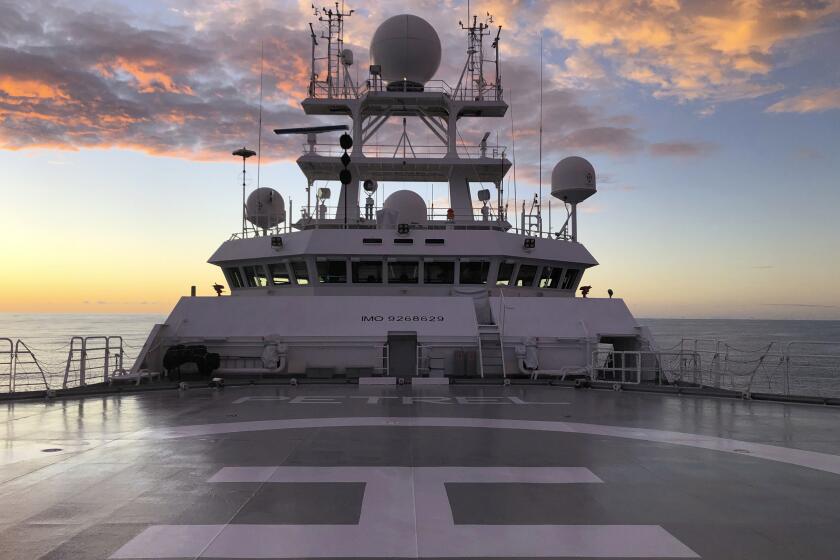 The sun rises over Vulcan Inc.'s research vessel Petrel nearly 200 miles off Midway Atoll in the Northwestern Hawaiian Islands on Friday, Oct. 18, 2019. The crew of the Petrel found the sunken remains of the Japanese aircraft carrier Kaga, which sank in the historic Battle of Midway, and are searching the vast area for other sunken warships in the coming days. (AP Photo/Caleb Jones)