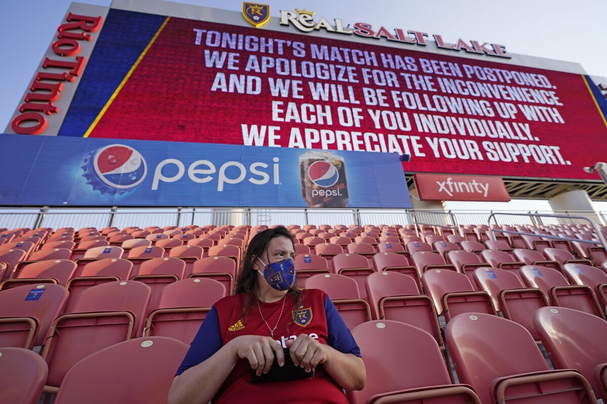 A fan sits in the stands after the scheduled game between Real Salt Lake and LAFC was postponed.