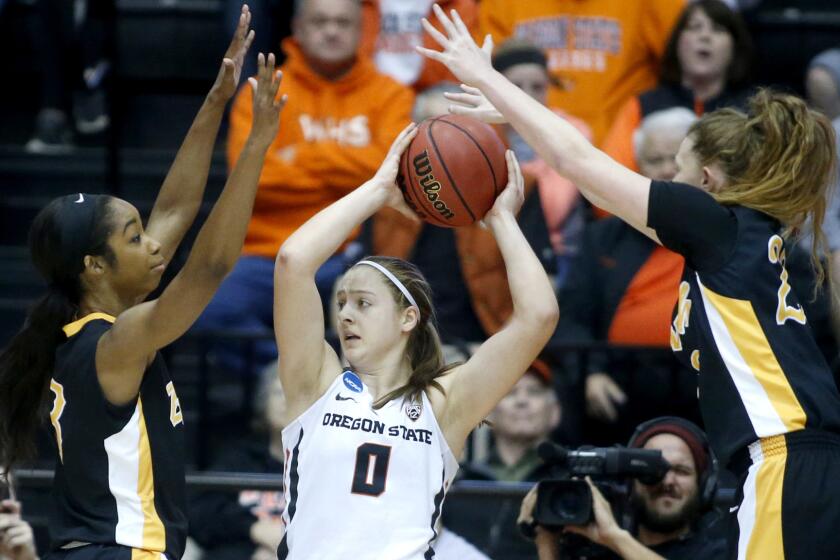 Oregon State's Mikayla Pivec (0) looks to pass against the double-team defense of Long Beach State's Chanterria Jackson, left, and Madison Montgomery during the first half Friday night.