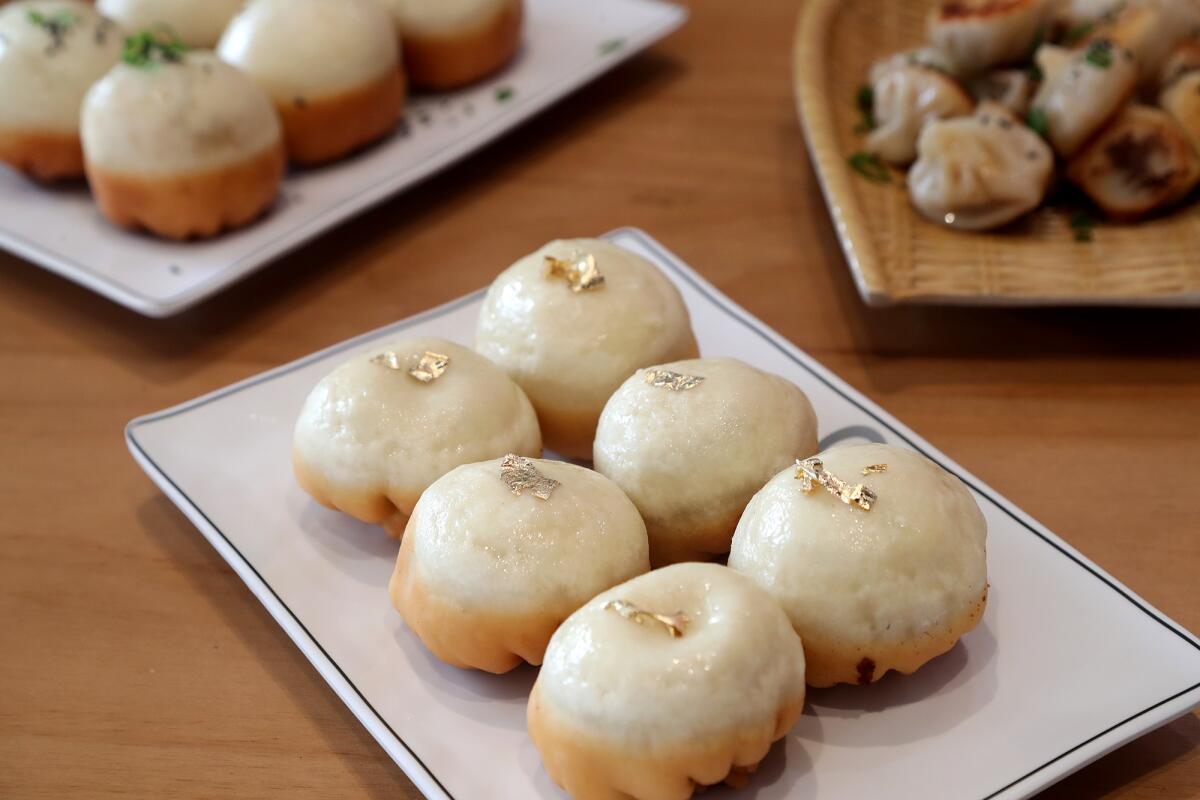 A plate of 24-karat gold-leaf black truffle buns at Little Pan Gourmet Juicy Pan-Fried Bun in Santa Ana.