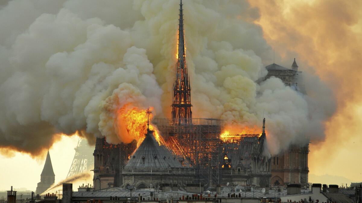 Flames and smoke rise from a massive fire Monday at Notre Dame Cathedral in Paris.