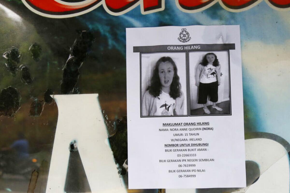 A poster of 15-year-old Nora Anne Quoirin is displayed on a window in Seremban, Malaysia.