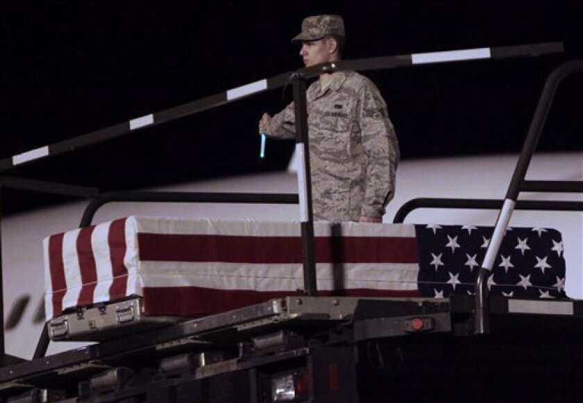The casket of Air Force Staff Sgt. Phillip Myers, of Hopewell, Va., who was killed Afghanistan on April 4 is lowered to the tarmac on Sunday, April 5, 2009 in Dover Air Force Base, Del. After receiving permission from the family, Myers is the first casualty to be observed arriving at Dover since the ban on media news coverage of returning war dead was put in place 18 years ago. (AP Photo/Evan Vucci)
