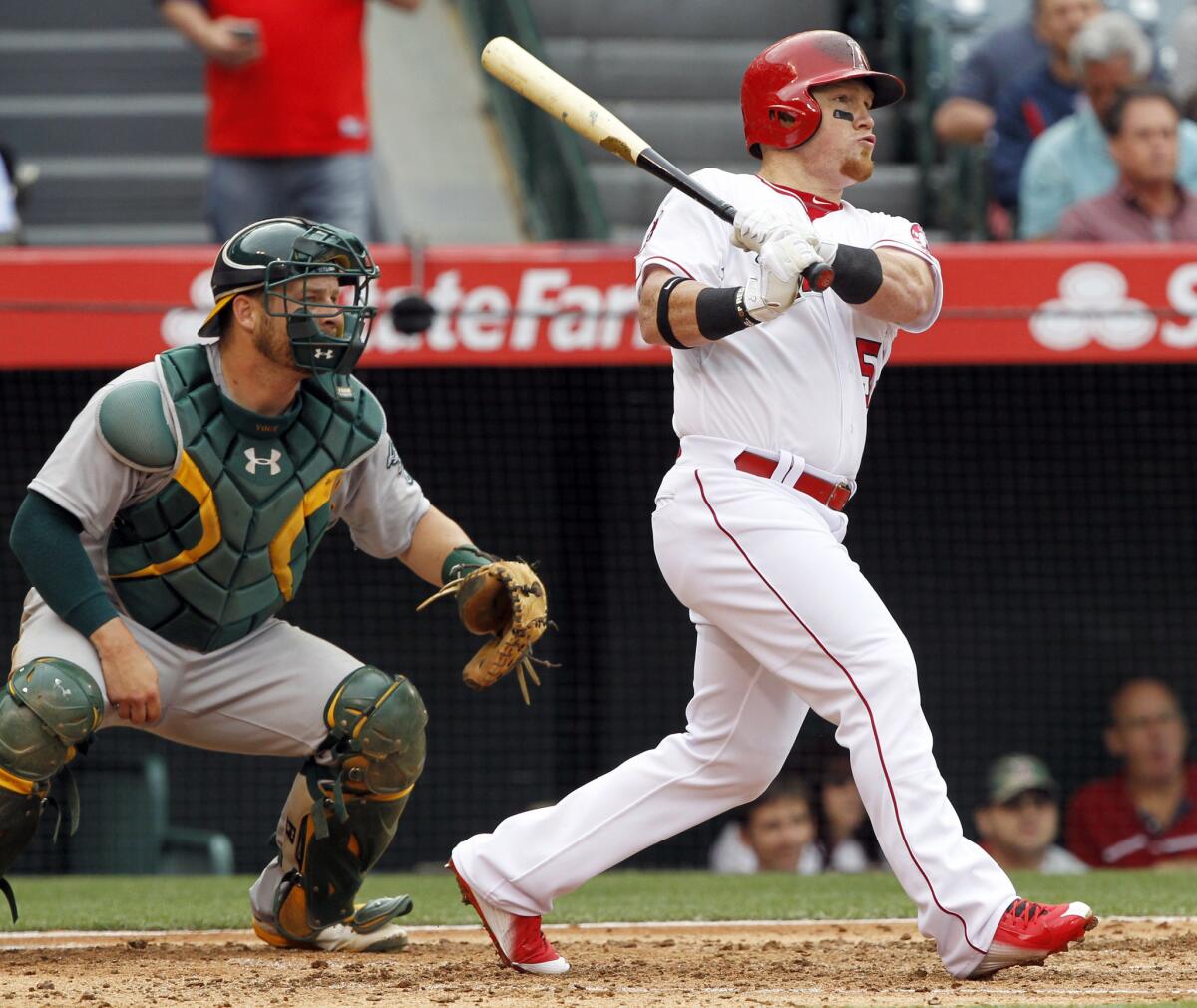 Outfielder kole Calhoun watches his two-run home run in the third inning against the Athletics -- the Angels' only hit of the game. The Angels won 2-0.