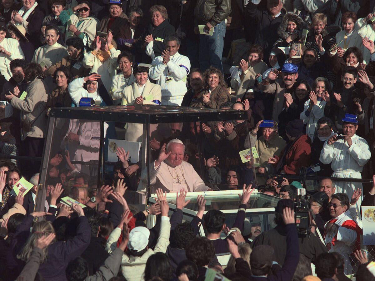 Pope John Paul II is greeted by the crowds as he makes his way to the Basilica of Guadalupe in Mexico City on Jan. 23, 1999.