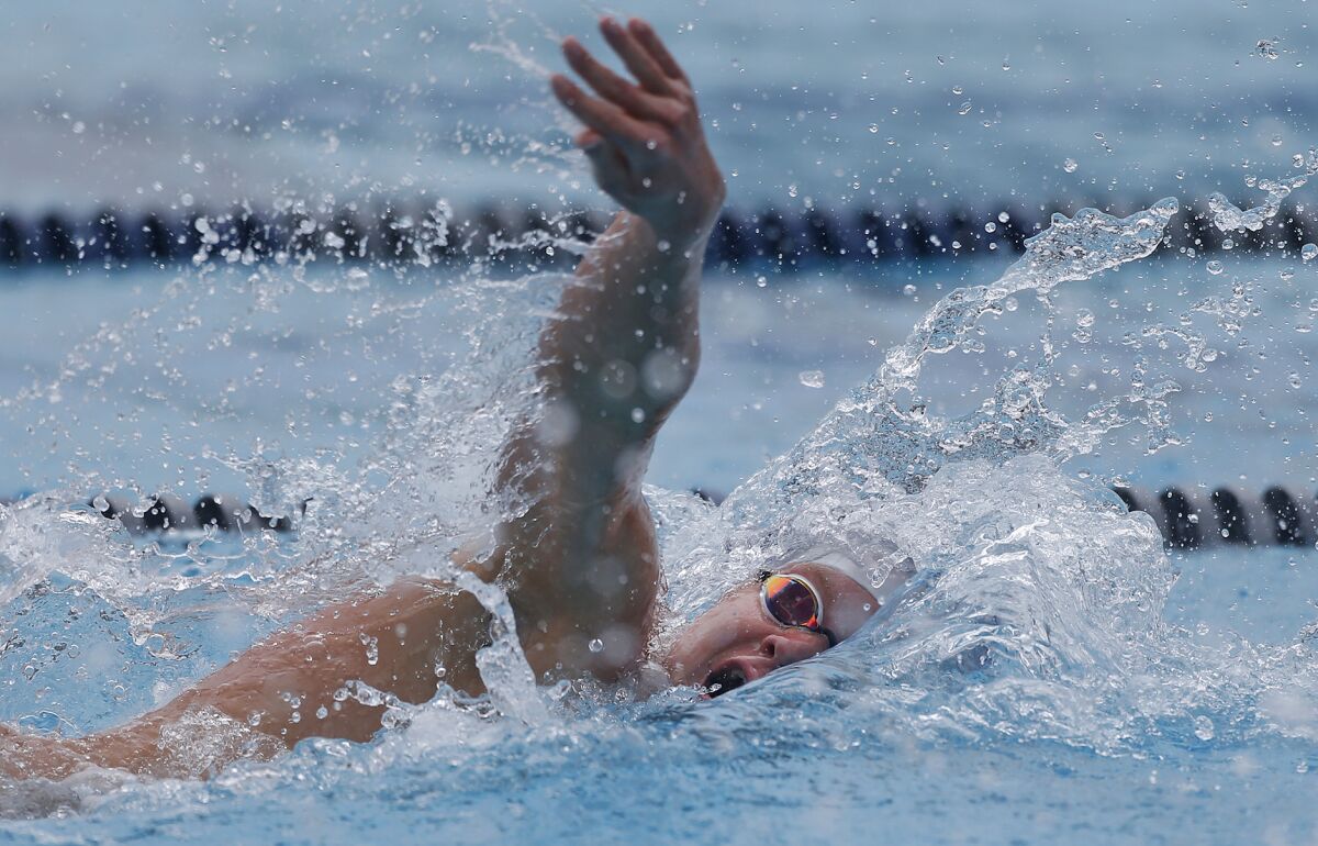 Ty Hansberger of Newport Harbor swims to first place in the boys' 200-yard freestyle during Tuesday's Battle of the Bay meet.