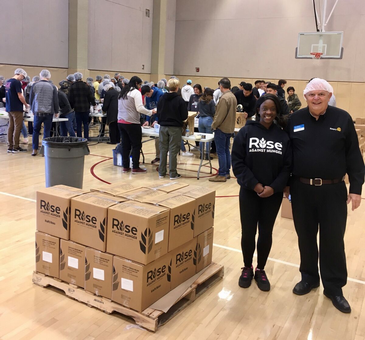Ron Wilson, president of the Route 78 Rotary, and Lakeysha Souwunmi from the San Diego office of Rise Against Hunger, at the recent meal-packing event at Mission Hills High School. 