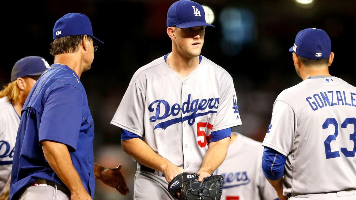 Dodgers starter Alex Wood leaves the mound after Manager Don Mattingly came to replace him in the second inning of a 12-4 loss to the Diamondbacks on Friday night.