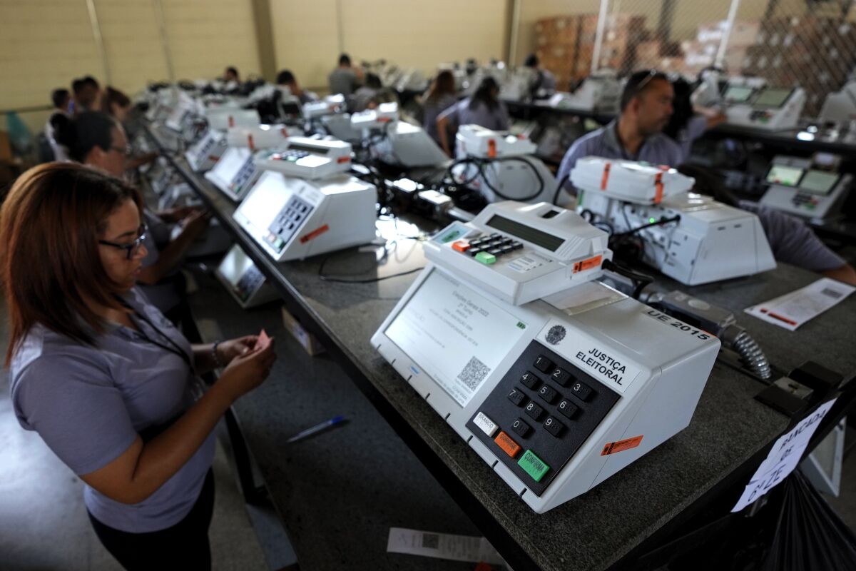 Brazilian election workers in room full of electronic voting machines