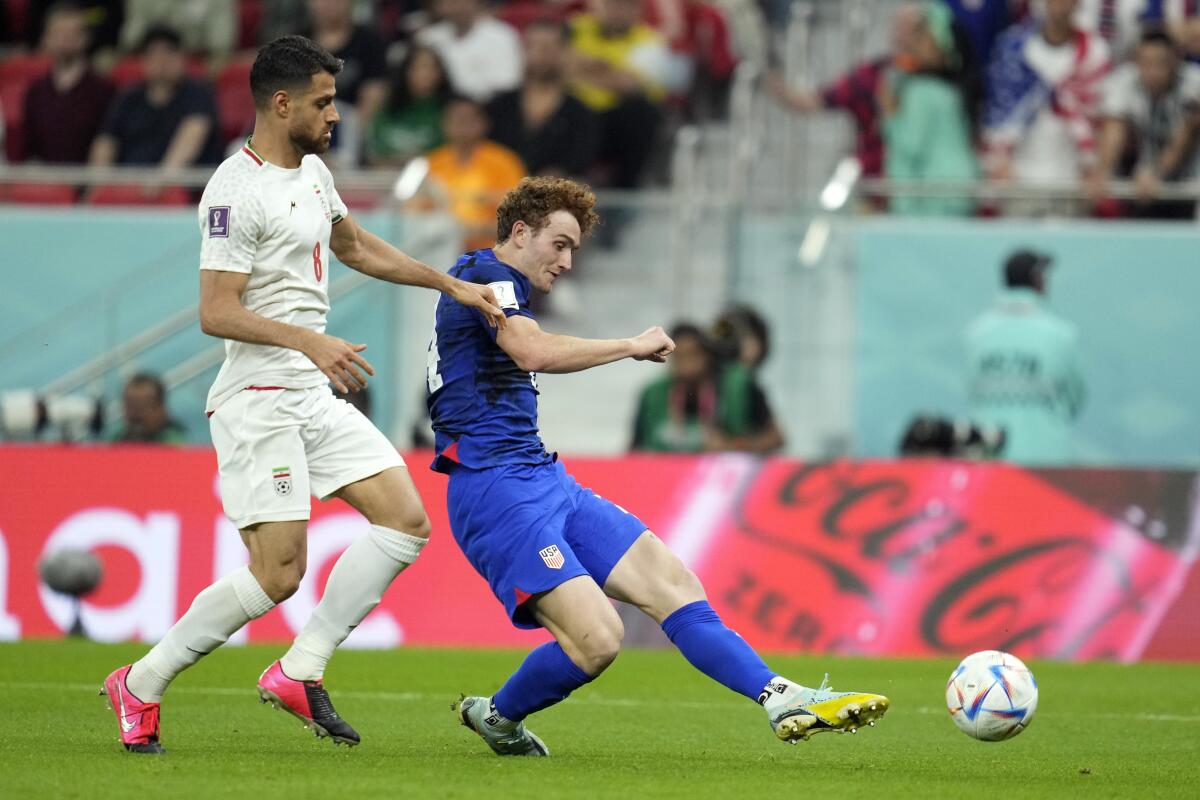 U.S. forward Josh Sargent, right, shoots in front of Iran's Morteza Pouraliganji during the second half.