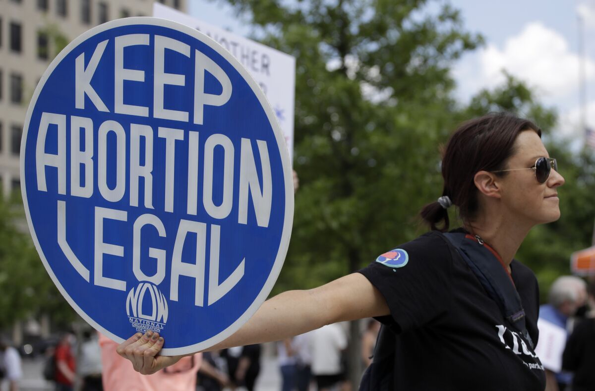 FILE - Abortion-rights demonstrator holds a sign during a rally on May 14, 2022, in Chattanooga, Tenn. In legislative sessions in 2023, GOP-controlled states have been moving to tighten abortion restrictions and those dominated by Democrats have continued to codify protections to abortion access. (AP Photo/Ben Margot, File)