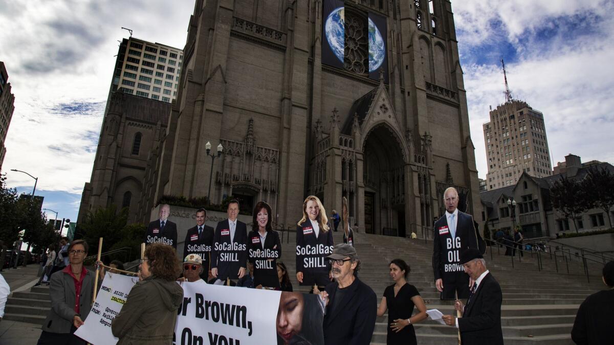 A small group of demonstrators rallies on the steps of Grace Cathedral to call on Gov. Jerry Brown to shut down the Aliso Canyon gas field just before the Wondering and Commitment ceremony inside the cathedral as a part of the Global Climate Action Summit.