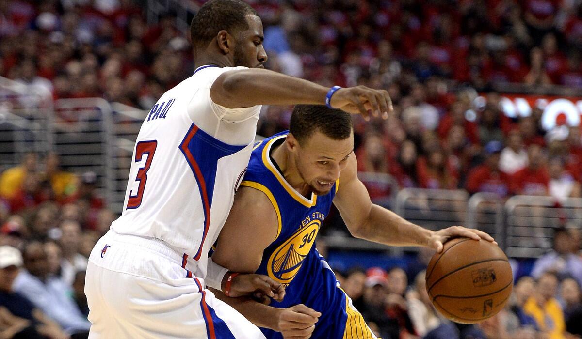 Clippers point guard Chris Paul tries to cut off a drive by Warriors point guard Stephen Curry during Game 1 of their playoff series.
