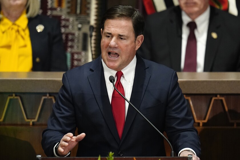 FILE — Arizona Republican Gov. Doug Ducey gives his state of the state address at the Arizona Capitol, Monday, Jan. 10, 2022, in Phoenix. Ducey sued the Biden administration, Friday, Jan. 21, 2022, over its demand that the state stop sending millions in federal COVID-19 relief money to schools that don't have mask requirements or that close due to COVID-19 outbreaks. (AP Photo/Ross D. Franklin, File)