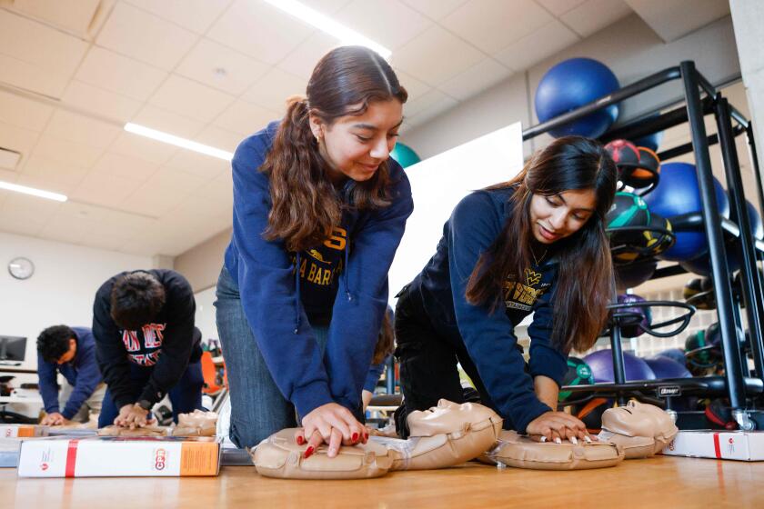 San Diego, CA - May 23: Martha Rico, 17, and Camilia Lopez, 18, practice CPR on an instructional doll at E3 High School on Thursday, May 23, 2024 in San Diego, CA. (Meg McLaughlin / The San Diego Union-Tribune)