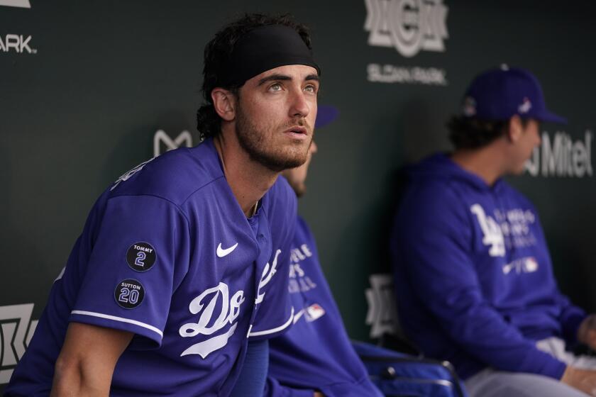 Los Angeles Dodgers center fielder Cody Bellinger (35) sits in the dugout before a spring training baseball game.