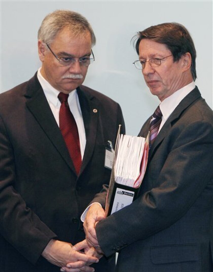 Berlin's interior senator Ehrhart Koerting, right, speaks to Rhineland-Palatinate state interior minister Karl Peter Bruch, left, on the final day of the ministers meeting in Potsdam, Germany, on Friday, Nov. 21, 2008. German security officials said Friday they will drop their attempt to pursue a ban of the Church of Scientology after finding insufficient evidence of unconstitutional activity. (AP Photo/Bernd Settnik Pool)