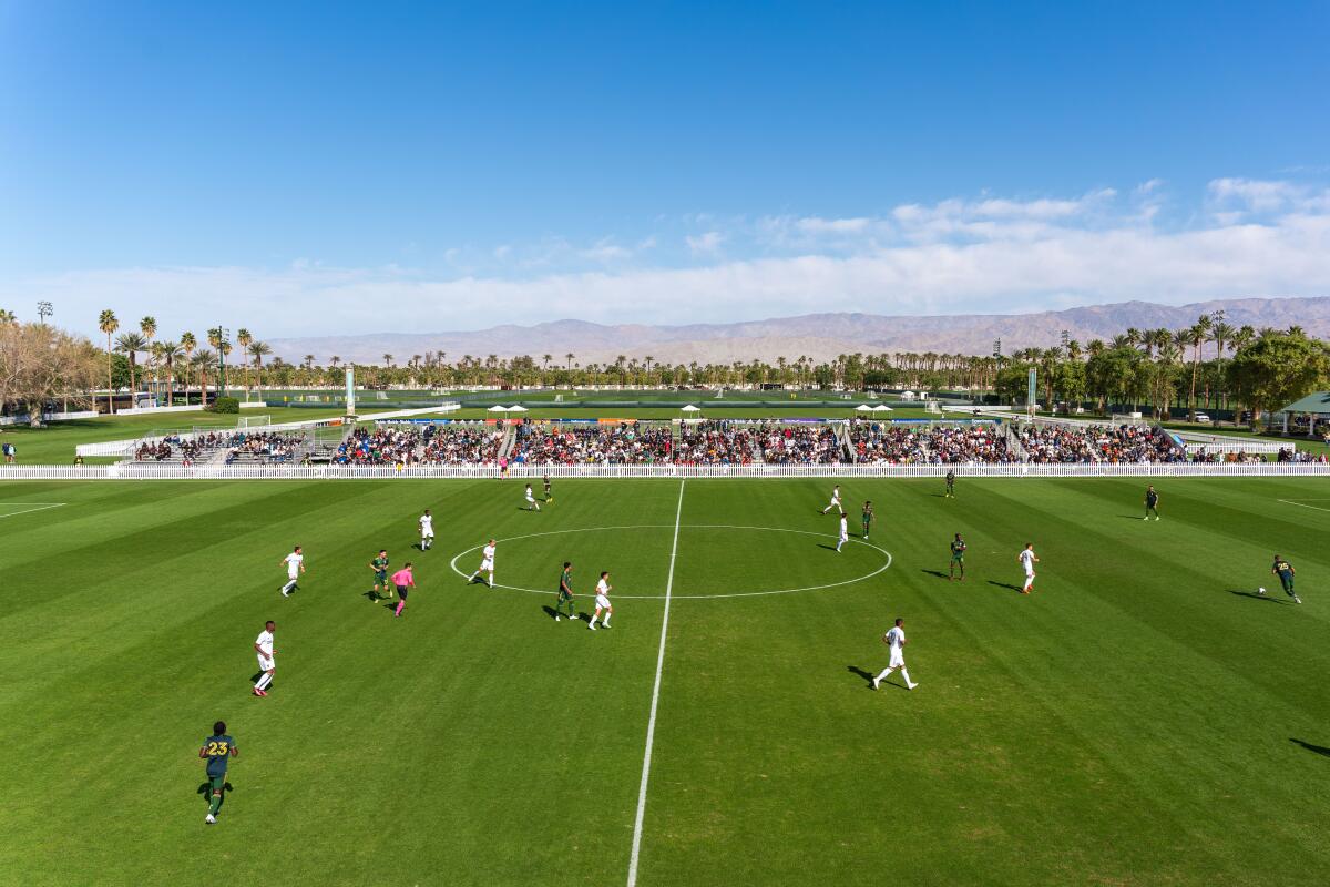 Players run on a soccer field in the Coachella Valley.