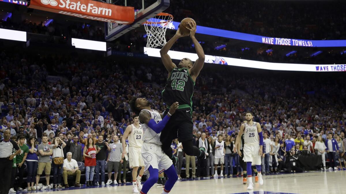 Boston Celtics' Al Horford goes up to shoot against Philadelphia 76ers' Robert Covington during overtime.