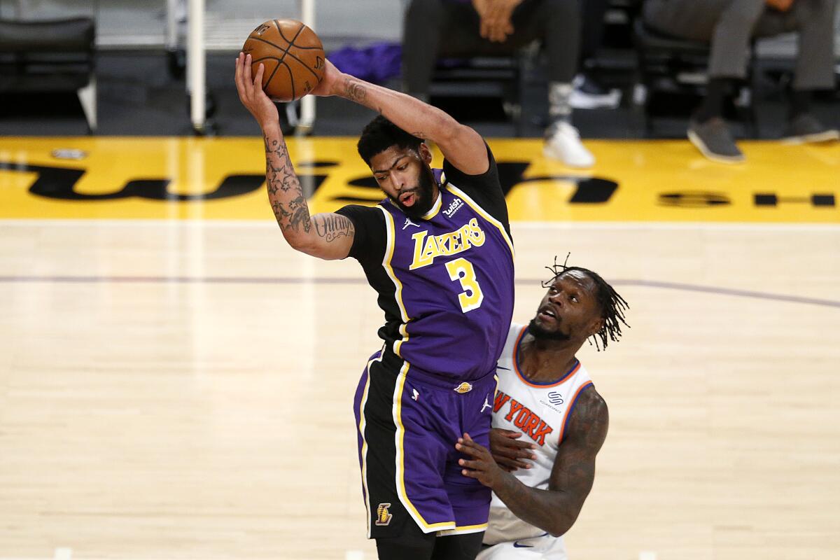 Lakers forward Anthony Davis is fouled by Knicks forward Julius Randle.