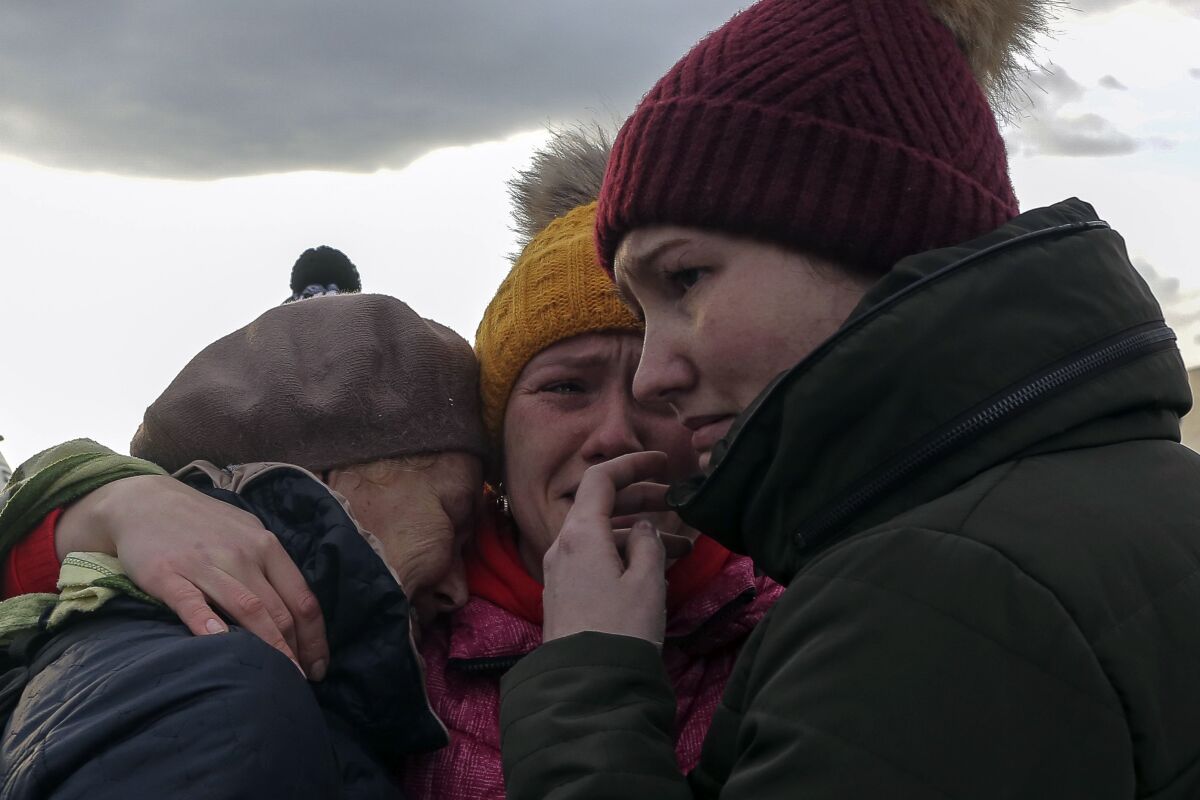Ukrainian refugees cry as they reunite at the Medyka border crossing