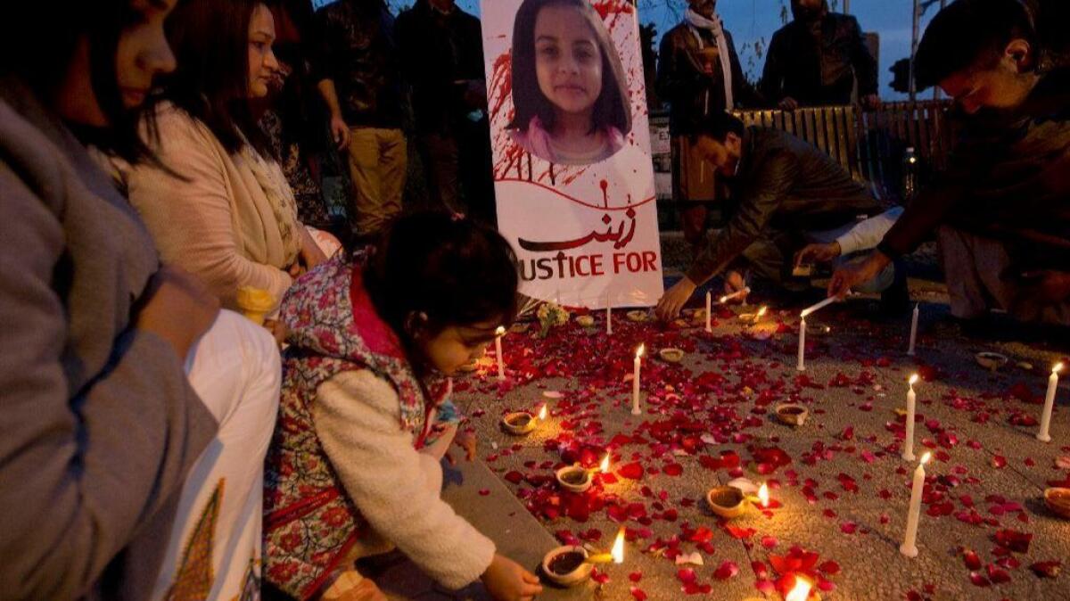 A Pakistani girl lights a candle during a memorial for Zainab Ansari in Islamabad, Pakistan, on Jan. 11, 2018.