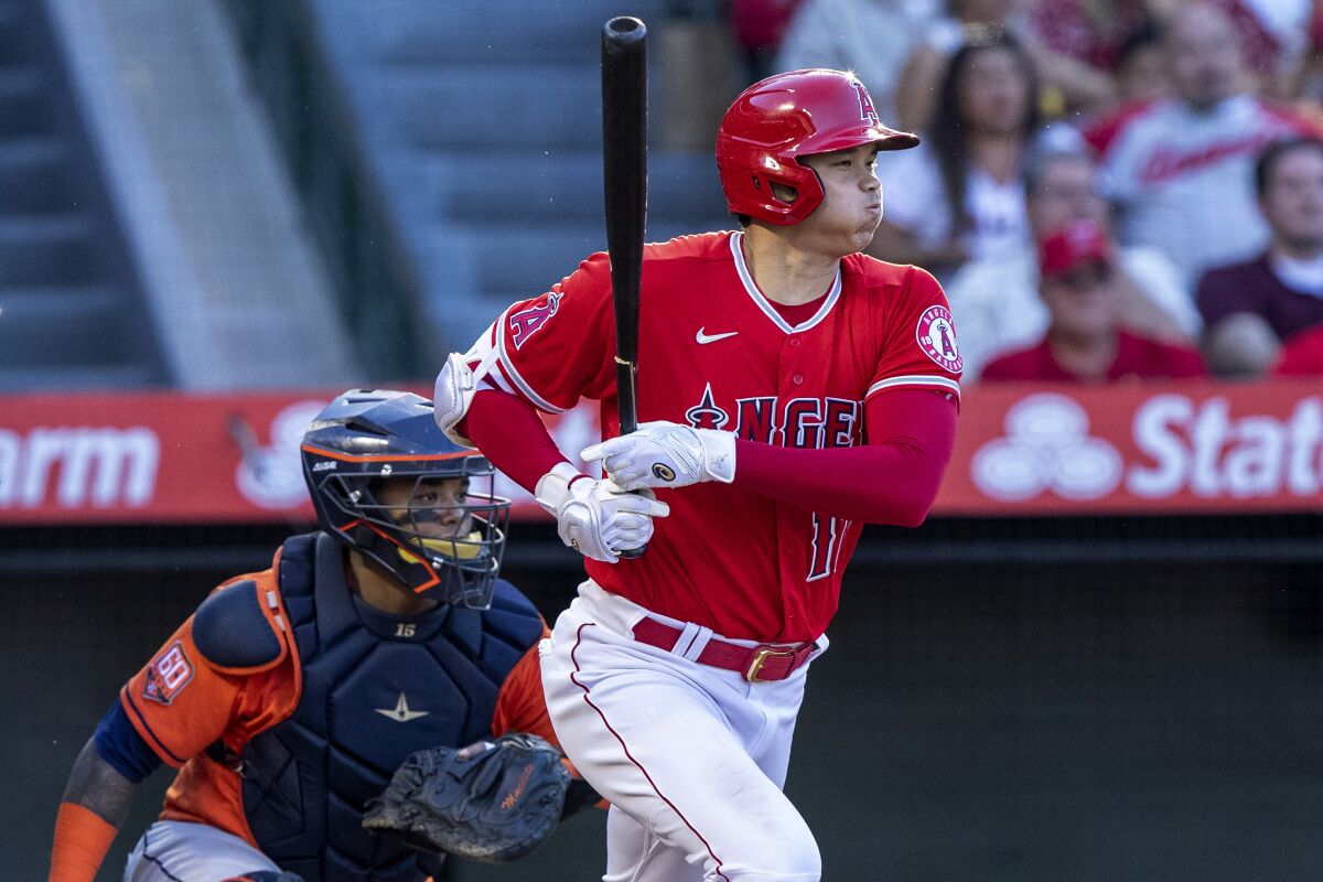 Angels' Shohei Ohtani watches his groundout next to Houston Astros catcher Martin Maldonado.