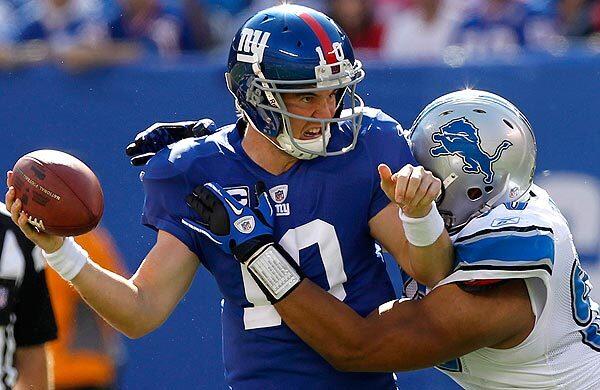 New York Giants quarterback Eli Manning is sacked by Detroit Lions defensive lineman Ndamukong Suh on Sunday at East Rutherford, N.J. Nevertheless, the Giants subdued the Lions, 28-20, as Manning tossed two touchdown passes.