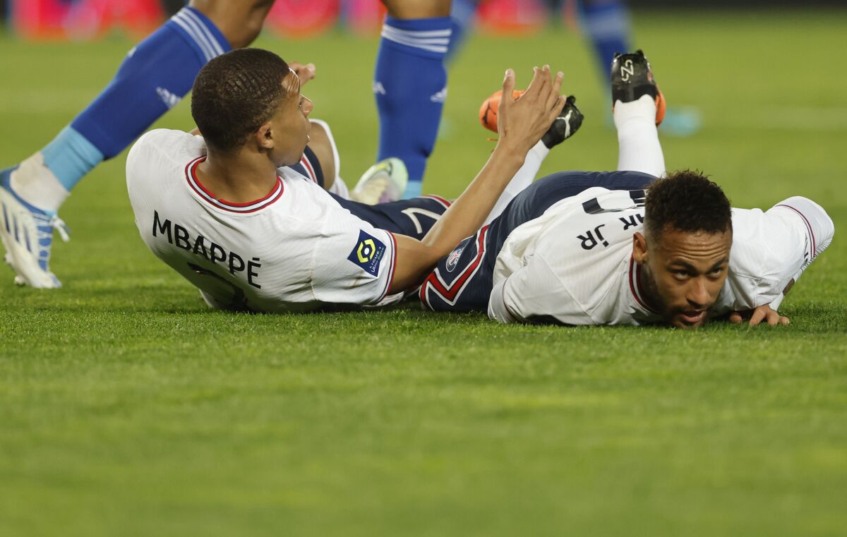 PSG's Kylian Mbappe, left, and PSG's Neymar during the French League One soccer match between Strasbourg and Paris Saint-Germain at Stade de la Meinau stadium in Strasbourg, eastern France, Friday, April 29, 2022. (AP Photo/Jean-Francois Badias)