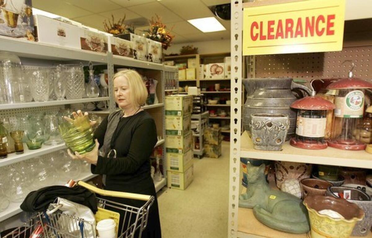 Curator Brooke Hodge checks out a chartreuse glass ice bucket at the store Tuesday Morning. This is an example of how something streamlined can be decorative without having too much ornamentation, she says. I am going to take this home, put gravel in the bottom and bulbs on top. It will look beautiful with paper whites.