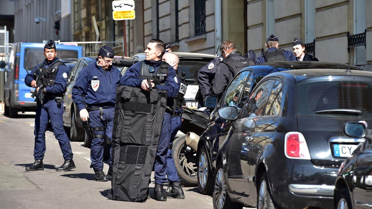 Police secure the area near the Paris offices of the International Monetary Fund on March 16, 2017, after a letter bomb exploded on the premises.