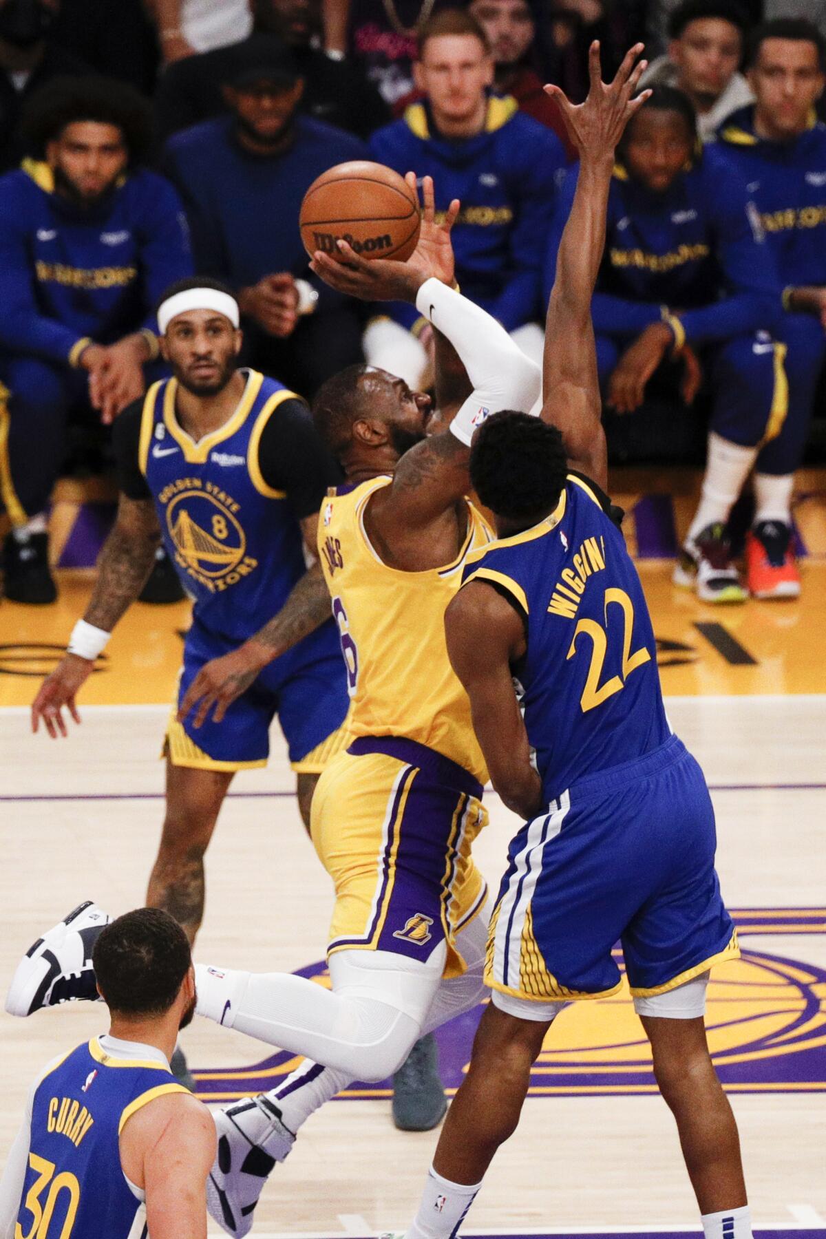 Lakers forward LeBron James, left, goes up for a shot while fouled by Warriors forward Andrew Wiggins during Game 6.