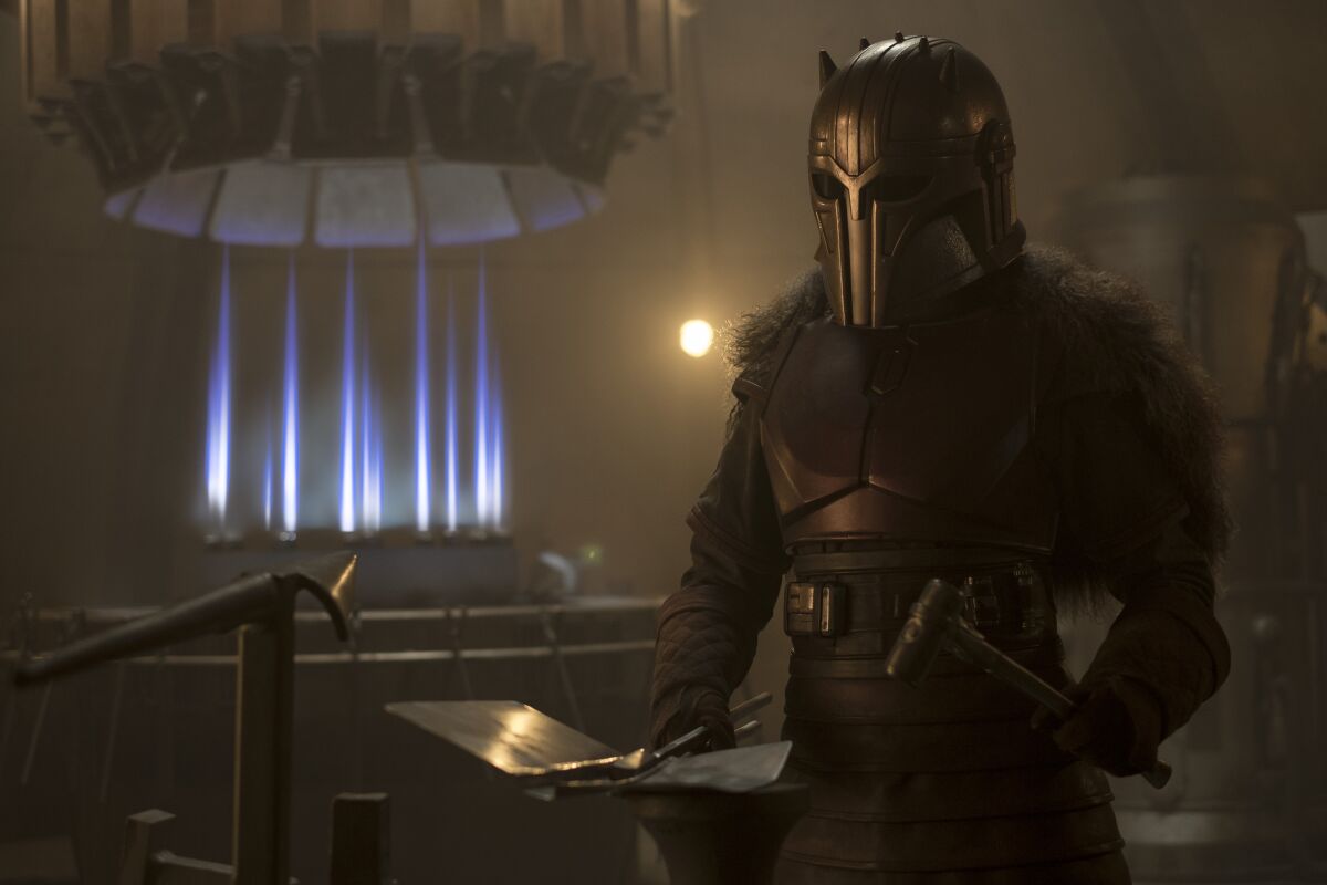 A woman wearing armor by her forge
