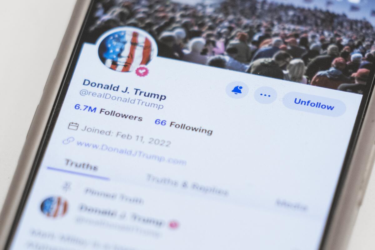 Former President Trump's Truth Social account on a phone screen.