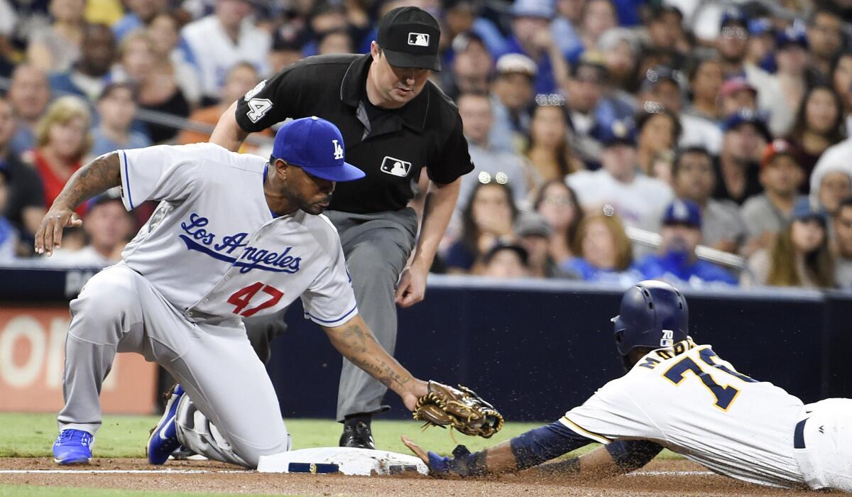 San Diego Padres' Manuel Margot steals third base ahead of the tag of Dodgers' Howie Kendrick during the fourth inning Wednesday.