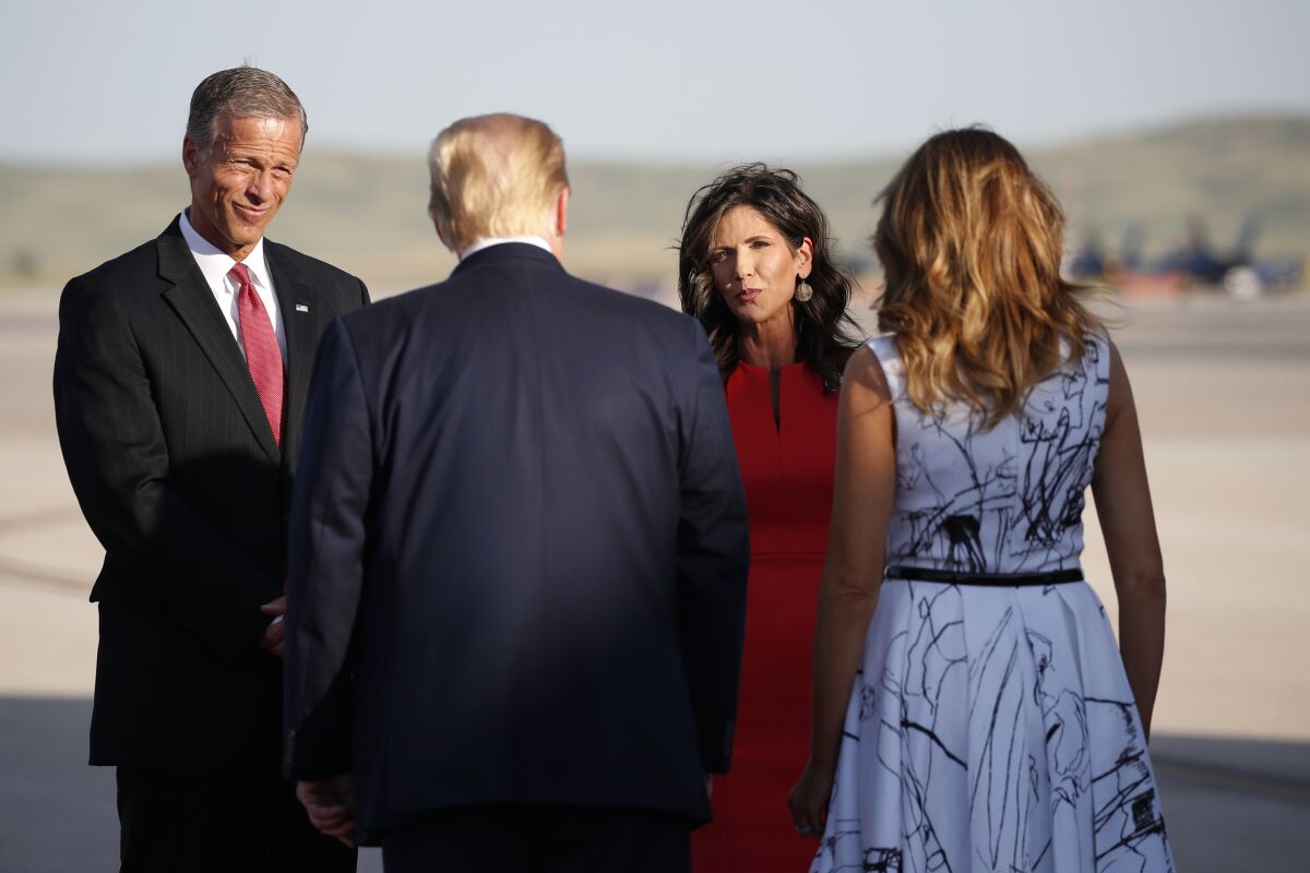 Sen. John Thune, R-S.D., and Gov. Kristi Noem greet President Donald Trump and first Lady Melania Trump upon arrival at Ellsworth Air Force Base, Friday, July 3, 2020, in Rapid City, S.D. Trump is en route to Mount Rushmore National Memorial. (AP Photo/Alex Brandon)