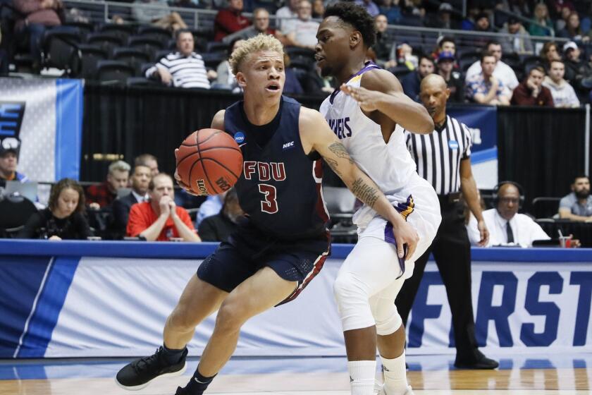 Fairleigh Dickinson's Jahlil Jenkins (3) drives against Prairie View A&M's Taishaun Johnson, right, during the first half of a First Four game of the NCAA college basketball tournament, Tuesday, March 19, 2019, in Dayton, Ohio. (AP Photo/John Minchillo)