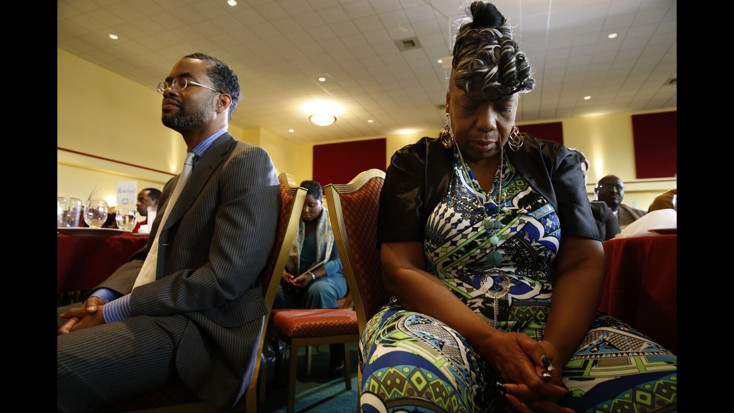 Gwen Carr, right, mother of Eric Garner, who was killed by a New York City police officer last year, attends a prayer lunch and community meeting in Baltimore.