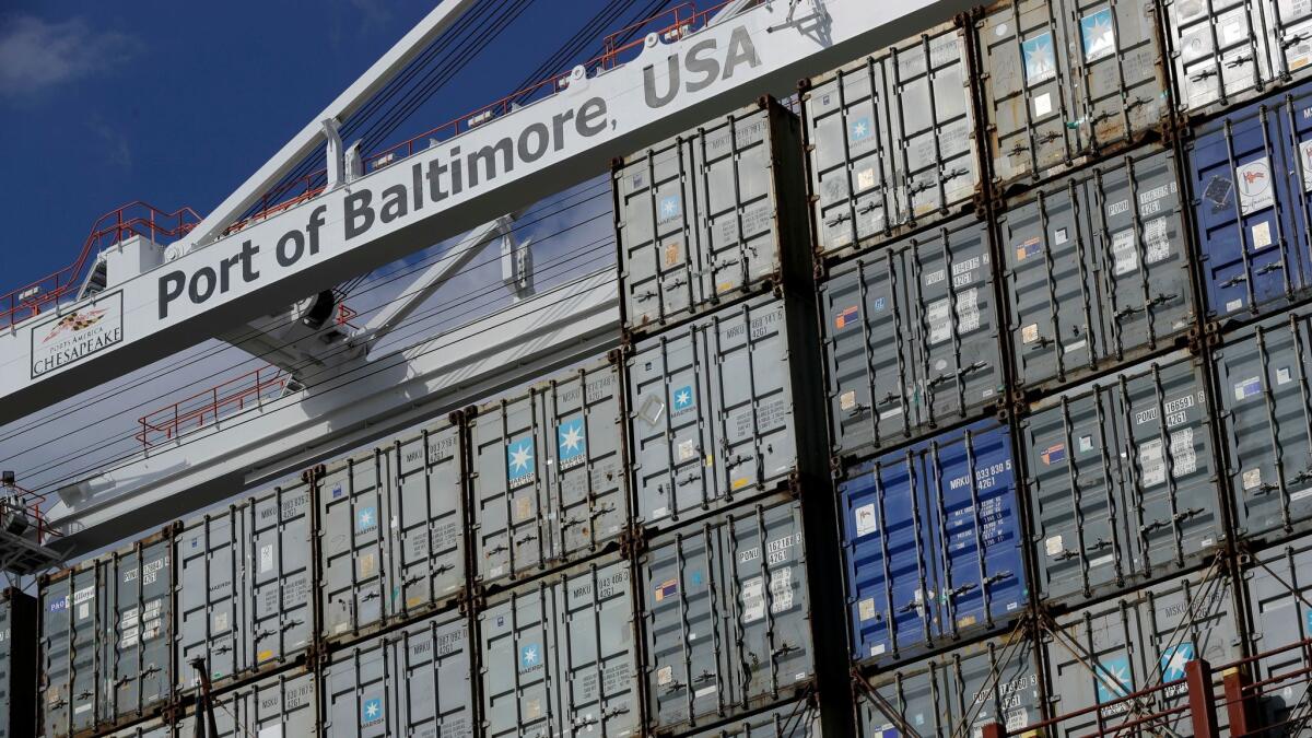 A crane hangs over a container ship in October 2016 at the Port of Baltimore in Baltimore. On Friday, the Commerce Department reports on the U.S. trade gap for June.