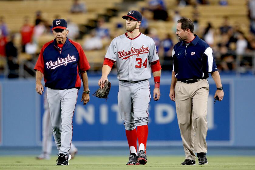 Washington Nationals right fielder Bryce Harper (34) walks off the field after running into the wall in the fifth inning.